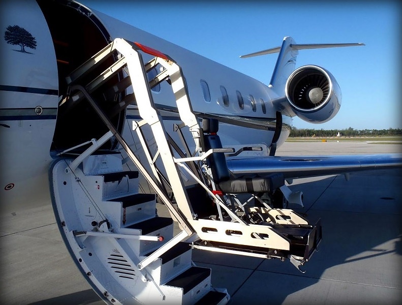 Wheelchair lift raising a passenger to a private aircraft door